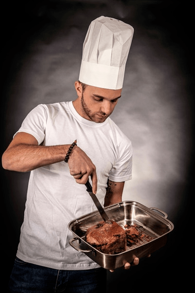 A man prepares meat for potential